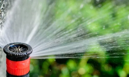 Close up photo of a irrigation head that was installed at a property in Geneva.